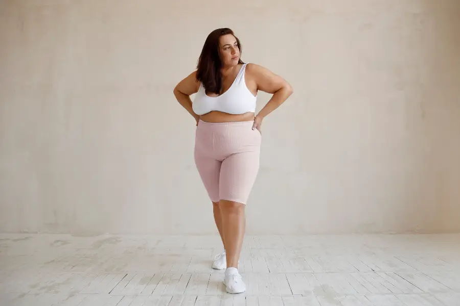 Full shot plus size model posing in studio